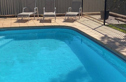 Forresters Beach House | Spacious holiday house ducted air conditioning walk to beach. In ground pool.