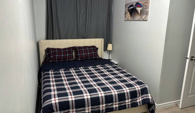 Clean, bright, modern room with a cozy queen bed, perfect for two adults. in Spruce Grove