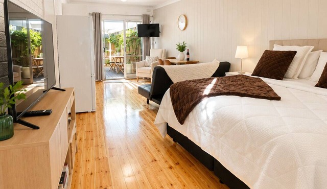 Coastal Retreat with Private Verandah - King Bed - Walk to Beach & Train